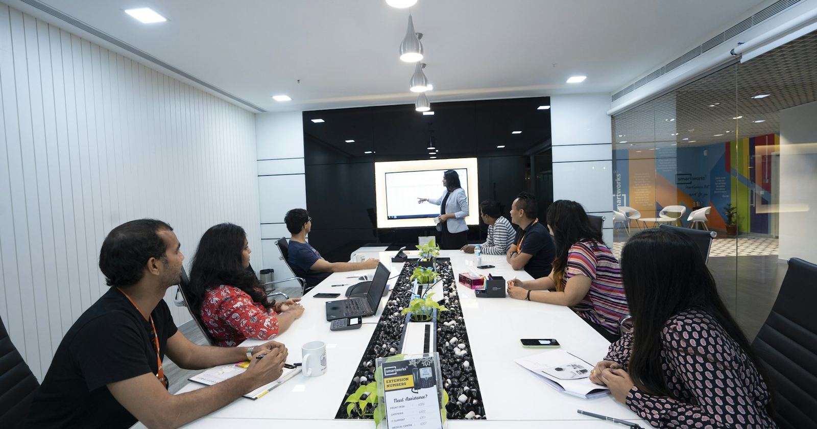 An Indian professional presenting to colleagues