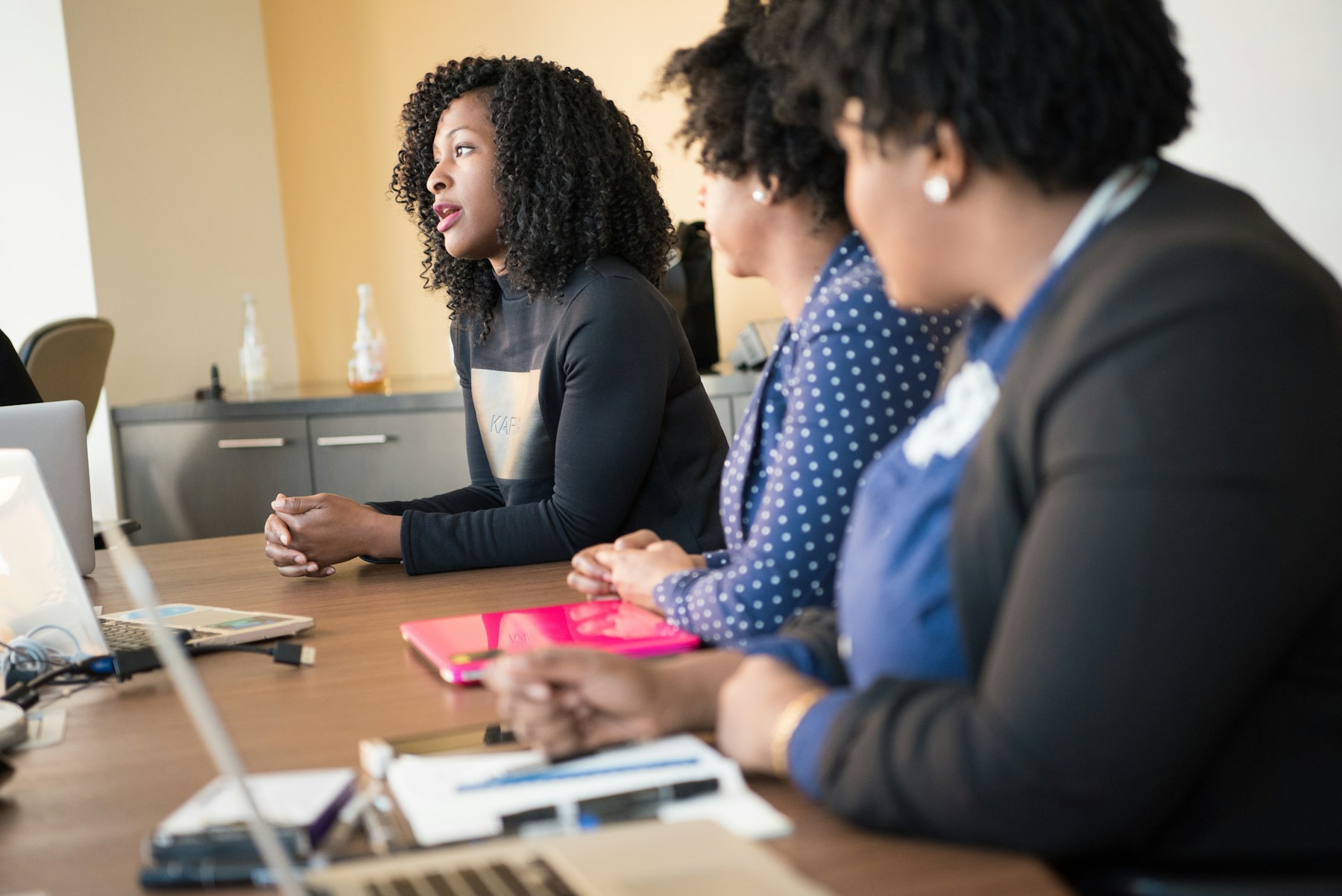 Women in technology discussing delivery priorities together